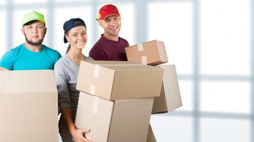 Professional movers handling furniture in Berrylands