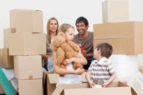Professional moving van with boxes and furniture in Berrylands